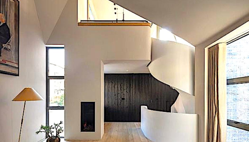 Bild: Interiören präglas av mörk träpanel, natursten och mässingsdetaljer. Ljussättningen är infälld och indirekt. Arkitekterna beskriver detta som en medveten kontrast mot den rationella och återhållsamma estetik som ofta förknippas med små bostäder. Foto: Nick Kane